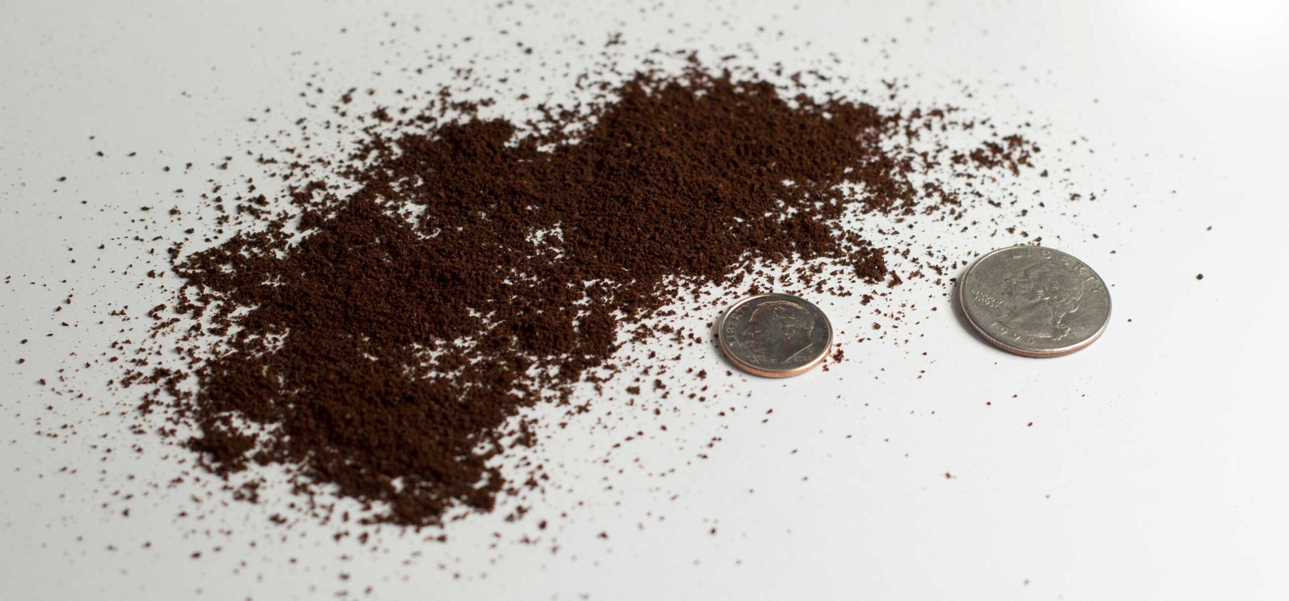 Finely ground coffee with evenly sized coffee granules, about the size for brewing espresso